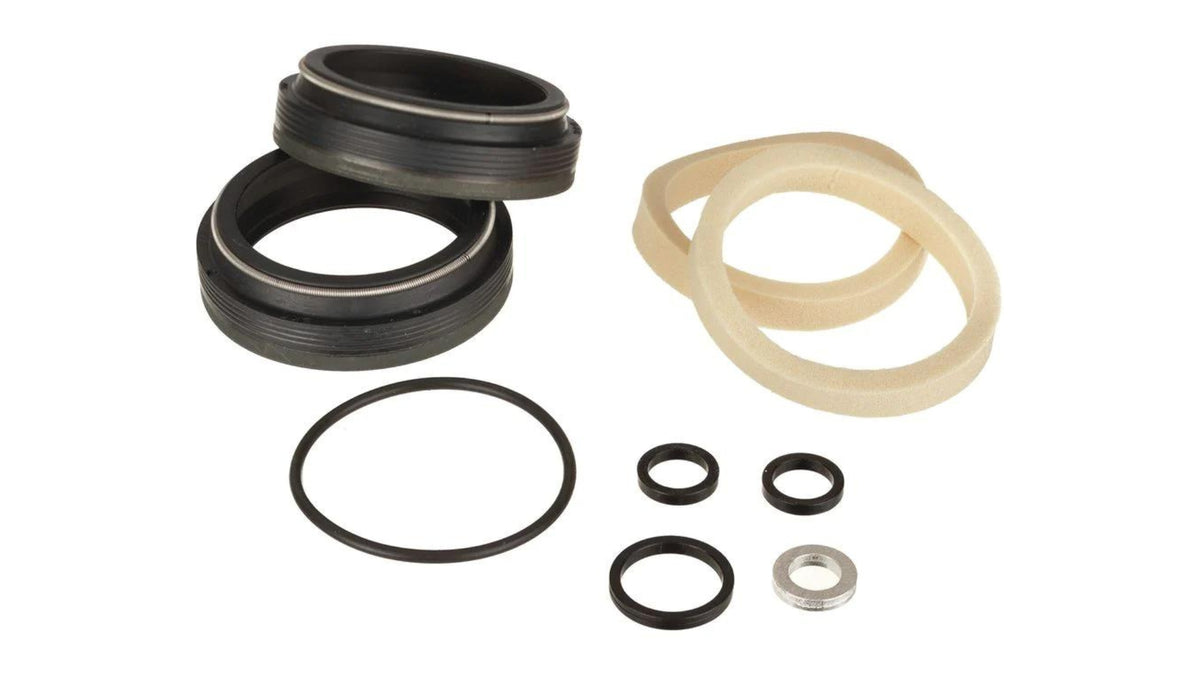 FOX 36mm low-friction flangeless dust wiper kit laid out on white: two black wiper seals, two tan foam rings, o-rings, and crush washers.
