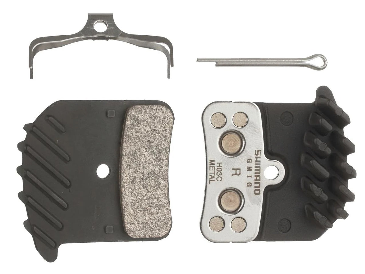 Shimano H03C finned metal disc brake pads with spring and cotter pin, on white background
