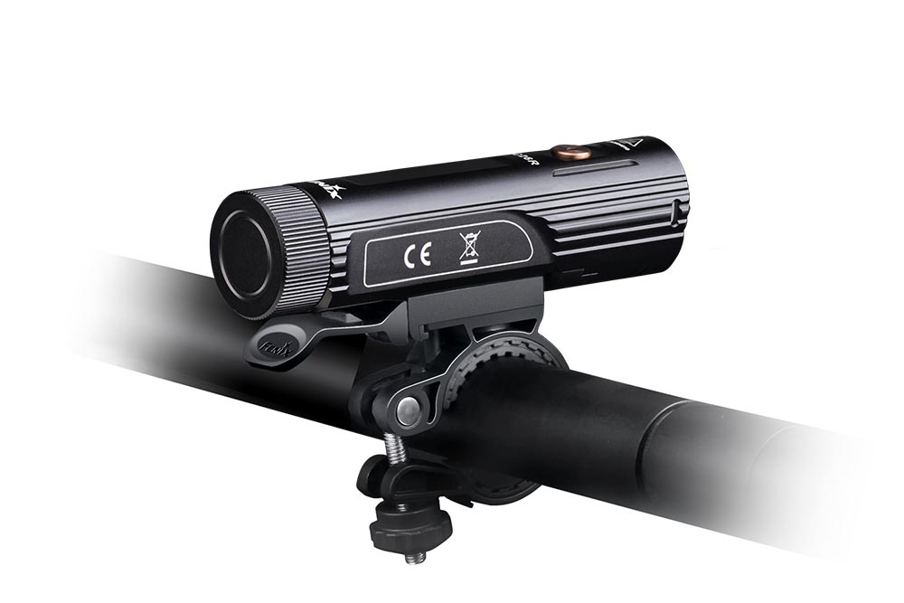 Fenix BC26R bike light mounted on a handlebar with the clamp mount, side view showing rear tail cap and CE marking