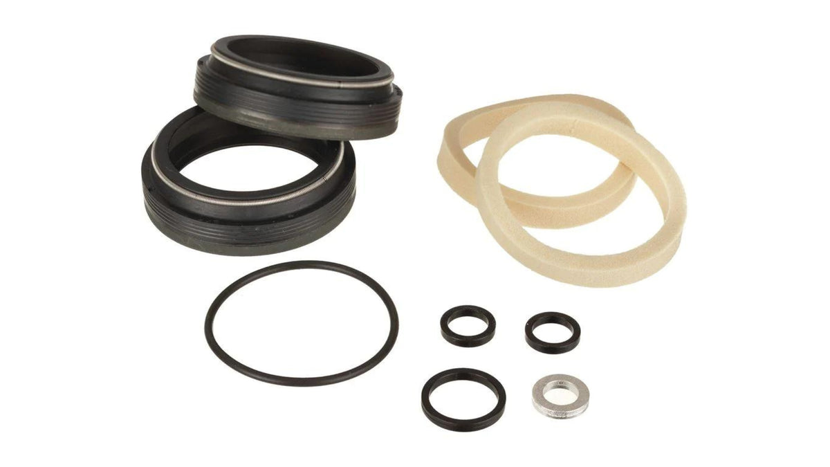 FOX 34mm low-friction flangeless dust wiper kit laid out on white: two black wiper seals, two tan foam rings, o-rings, and crush washers.