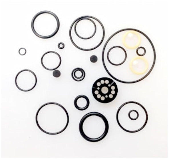 FOX Float DPX2 rebuild seal kit: assorted black o-rings and seals plus a black damper piston disc arranged on a white background.