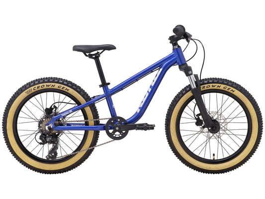 Kona Honzo 20 youth mountain bike in blue with tan sidewall Vee Crown Gem tires and black components, side view with drivetrain