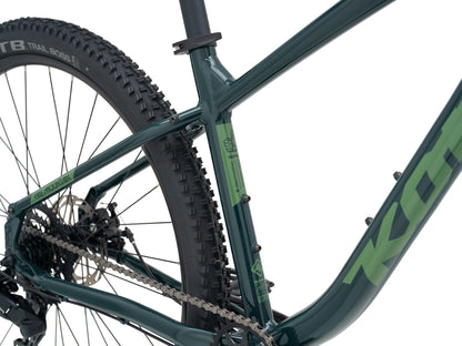 Kona Fire Mountain 2026 hardtail mountain bike in Gloss Emerald green, close-up detail of Kona head badge and Fire Mountain top tube decal