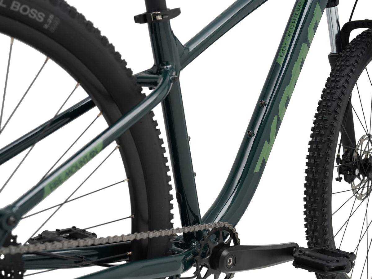 Kona Fire Mountain 2026 hardtail mountain bike in Gloss Emerald green, close-up detail of bottom bracket, crankset, and down tube decal