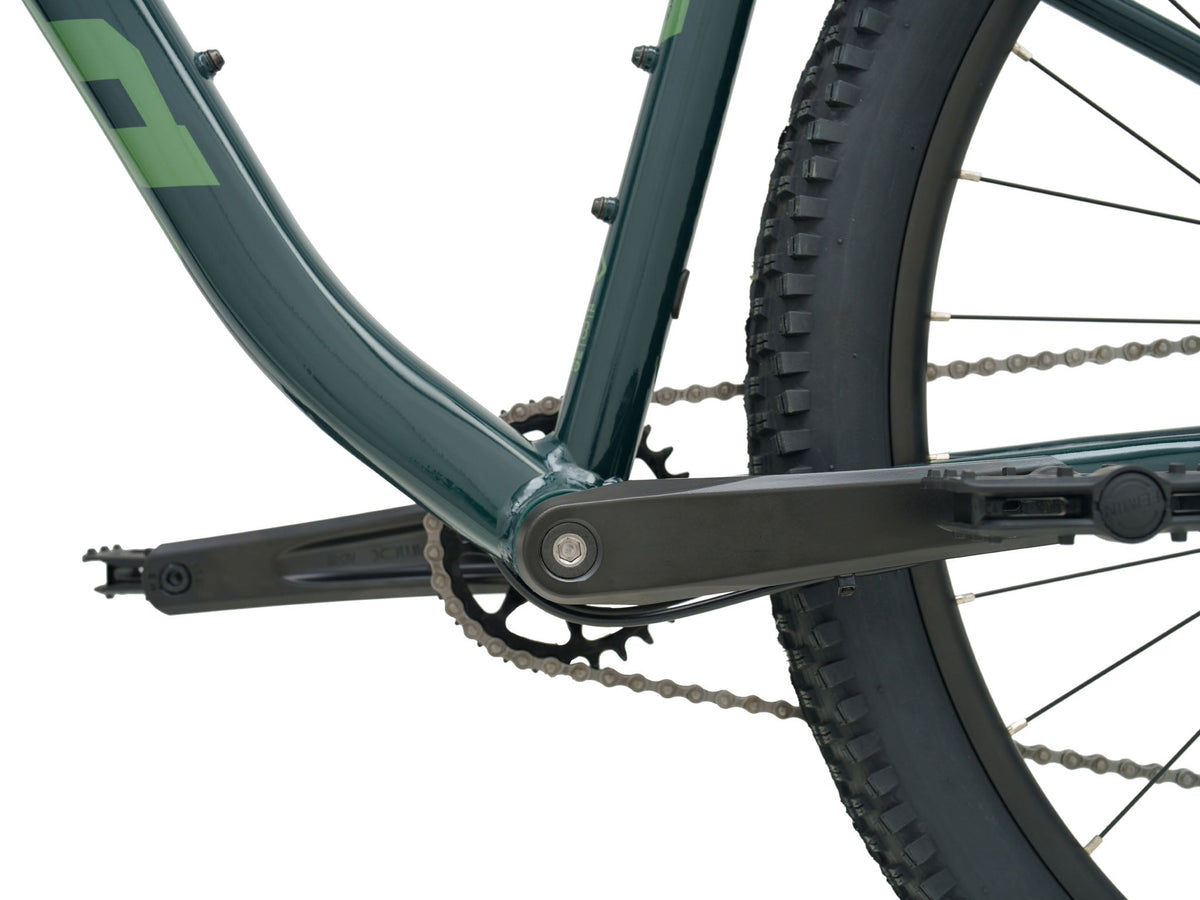 Kona Fire Mountain 2026 hardtail mountain bike in Gloss Emerald green, close-up detail of crankset, chain, and rear wheel
