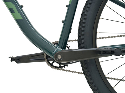 Kona Fire Mountain 2026 hardtail mountain bike in Gloss Emerald green, close-up detail of crankset, chain, and rear wheel