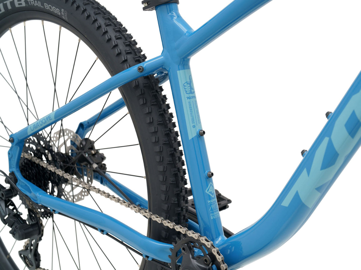 Kona Lava Dome 2026 hardtail mountain bike in Gloss Celestial Blue, close-up detail of rear wheel, chain, and seat tube