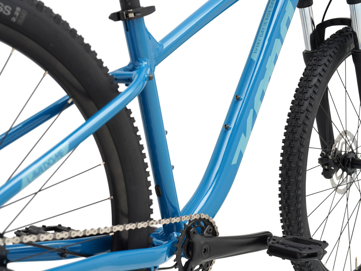 Kona Lava Dome 2026 hardtail mountain bike in Gloss Celestial Blue, close-up detail of bottom bracket, crankset, and down tube