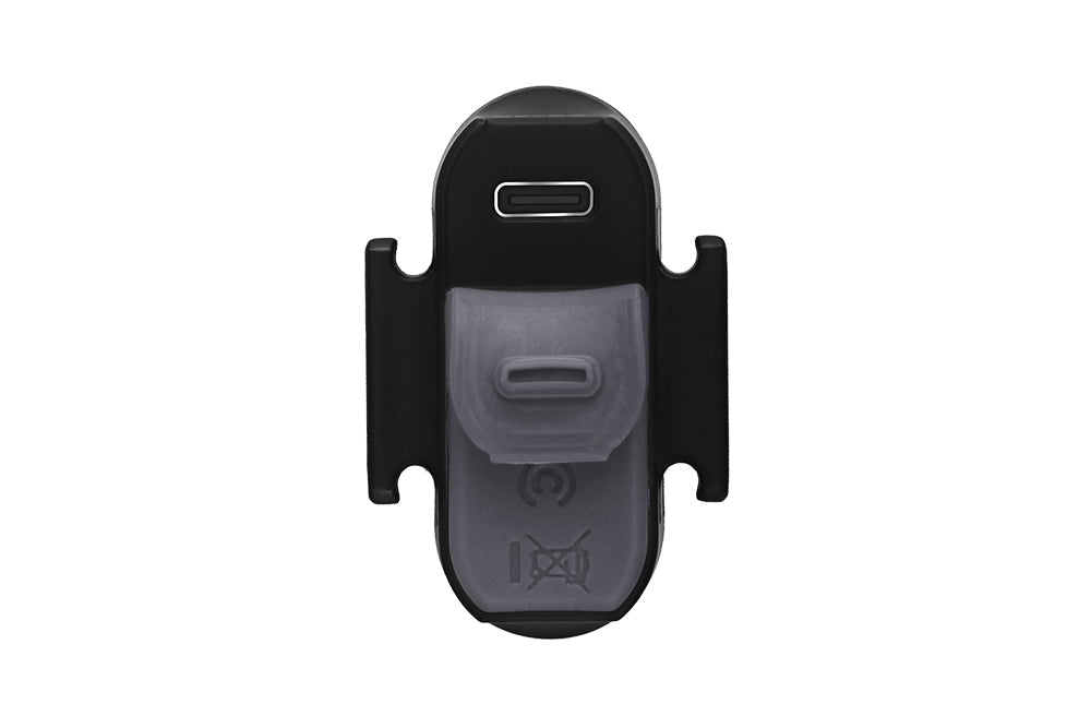 Fenix BC05R V2.0 tail light bottom view showing USB-C charging port cover and translucent silicone strap mount, white studio background