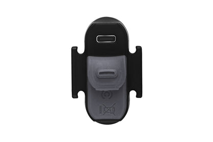 Fenix BC05R V2.0 tail light bottom view showing USB-C charging port cover and translucent silicone strap mount, white studio background