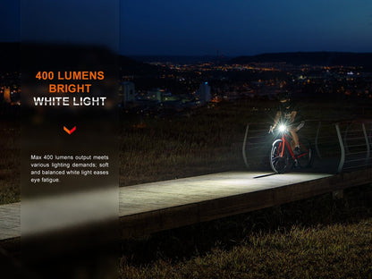 Fenix BC15R 400 lumens bright white light: cyclist riding on a boardwalk at night, soft and balanced white beam that eases eye fatigue