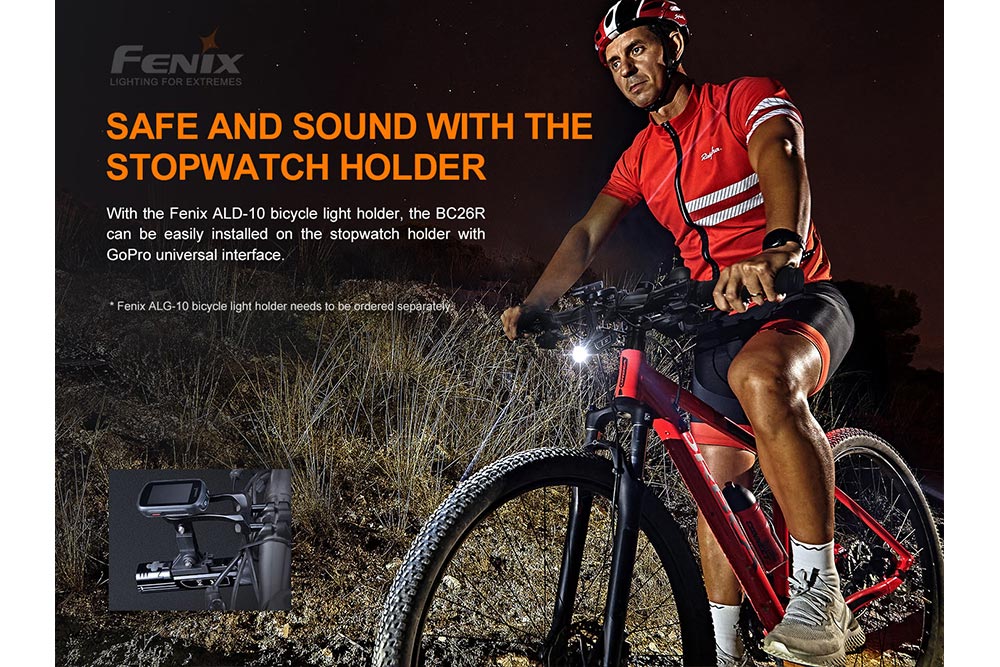 Fenix BC26R installed with the ALD-10 bicycle light holder on a stopwatch mount with GoPro universal interface, cyclist riding at night