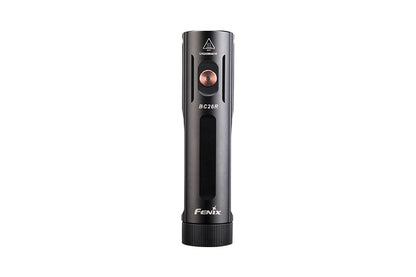 Fenix BC26R bike light top view showing copper power button, BC26R marking, hot surface warning symbol, and Fenix branding on black aluminum body
